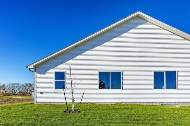 view of side of property with a lawn