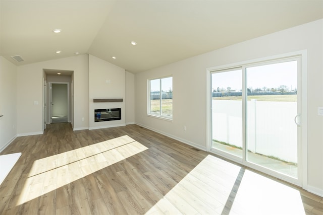 unfurnished living room with lofted ceiling and light hardwood / wood-style flooring