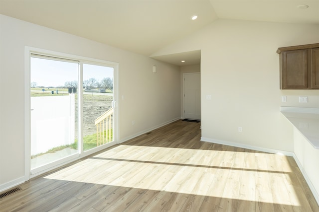 interior space with light hardwood / wood-style flooring and lofted ceiling