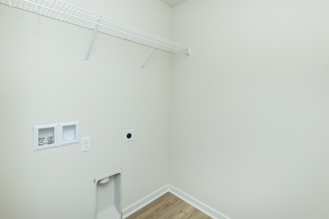 laundry area with wood-type flooring, hookup for a washing machine, and hookup for an electric dryer