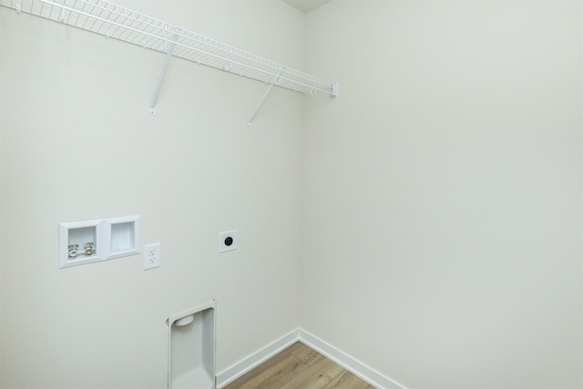 6573 NE 11th Ct, Des Moines, IA 50313 - laundry room featuring hookup for an electric dryer, baseboards, washer hookup, and light wood finished floors