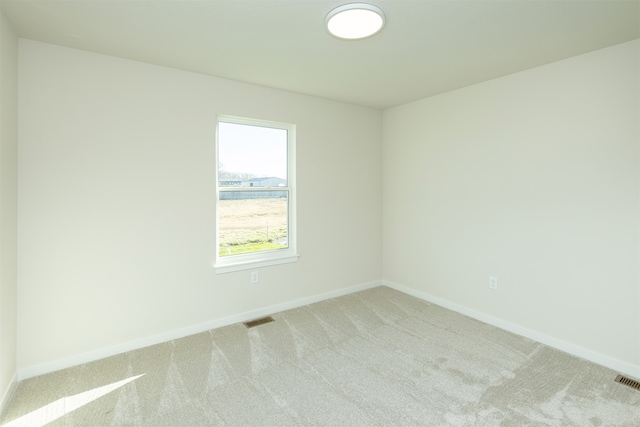unfurnished room with light colored carpet