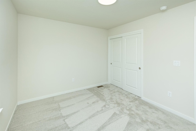 6573 NE 11th Ct, Des Moines, IA 50313 - unfurnished bedroom with carpet floors, baseboards, and a closet
