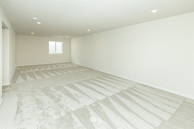 unfurnished room featuring light colored carpet