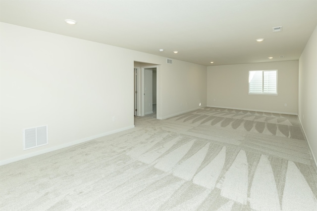 spare room featuring light colored carpet