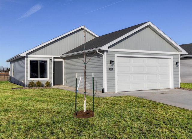 single story home with a garage and a front lawn