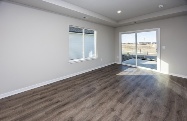 unfurnished room with dark wood-type flooring