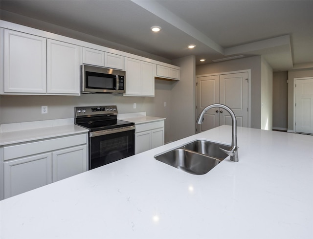 kitchen with white cabinetry, appliances with stainless steel finishes, and sink