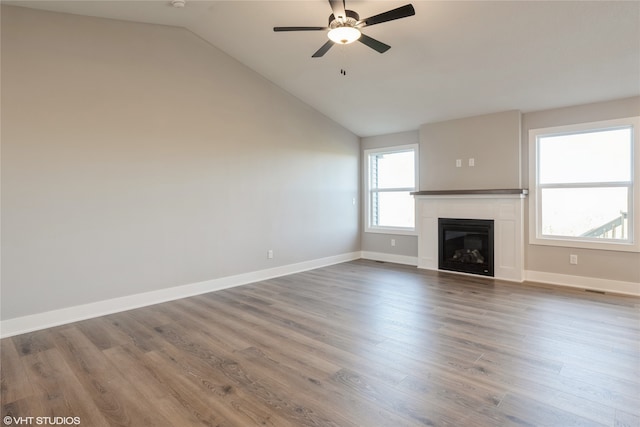 unfurnished living room featuring ceiling fan, wood-type flooring, and vaulted ceiling