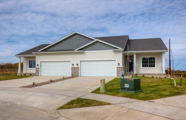 view of front facade with a front yard and a garage