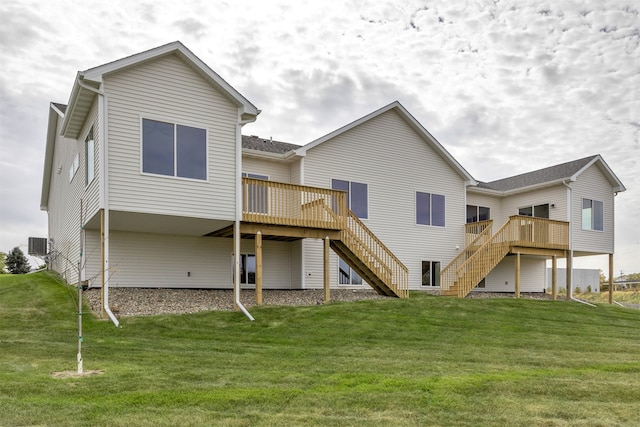 back of house with a deck, a lawn, and central AC unit