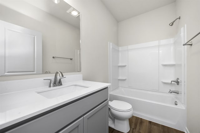 full bathroom with vanity, toilet, bathtub / shower combination, and wood-type flooring