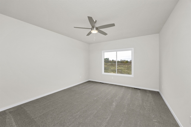 carpeted empty room featuring a textured ceiling and ceiling fan