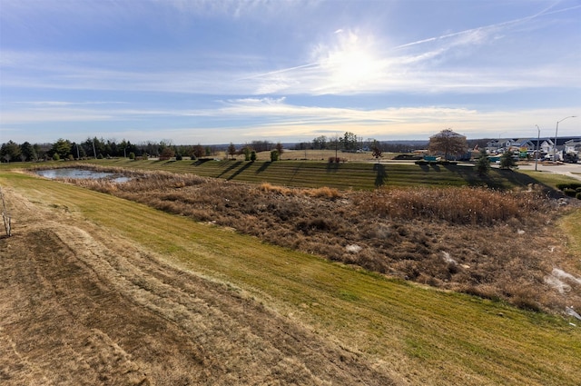 view of yard featuring a rural view and a water view