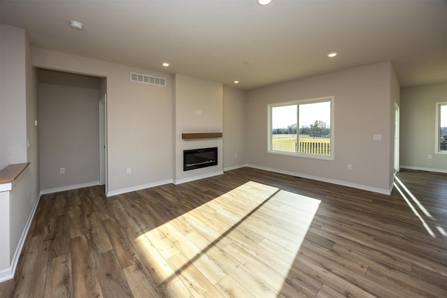 unfurnished living room featuring dark hardwood / wood-style flooring