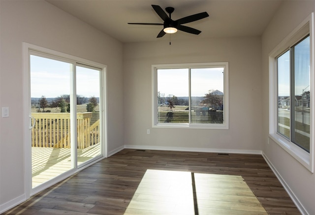 empty room featuring ceiling fan and dark hardwood / wood-style floors