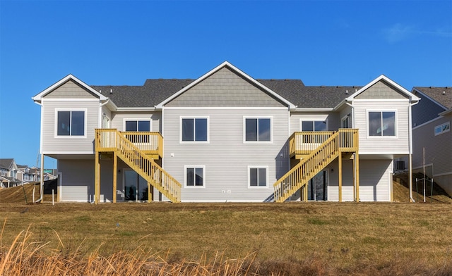 back of house with a lawn and a deck