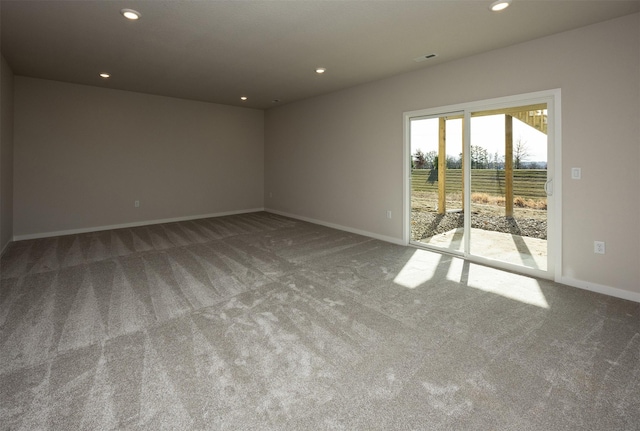 spare room with carpet flooring and a rural view