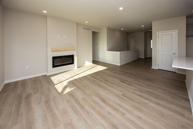 unfurnished living room featuring light wood-type flooring