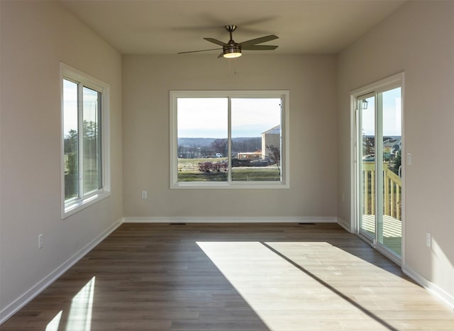 spare room with dark hardwood / wood-style floors and ceiling fan