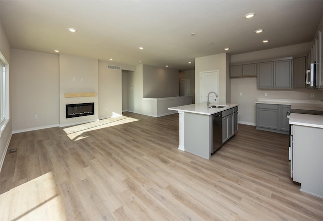 kitchen featuring gray cabinets, sink, appliances with stainless steel finishes, and light hardwood / wood-style flooring