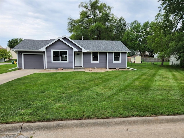 ranch-style house featuring a garage and a front lawn