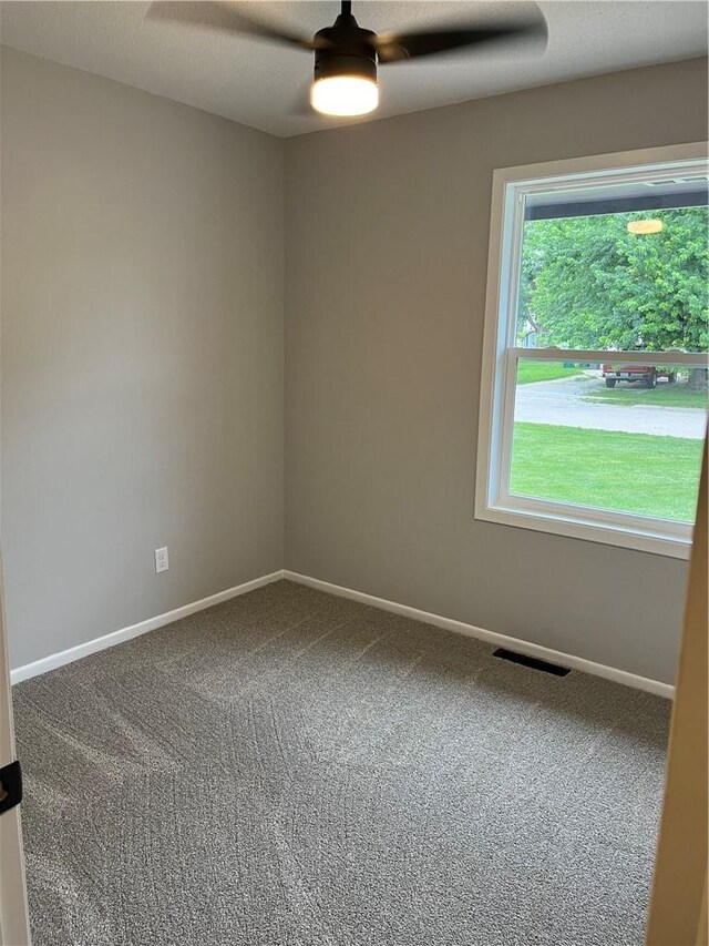 empty room featuring carpet floors, a textured ceiling, and ceiling fan