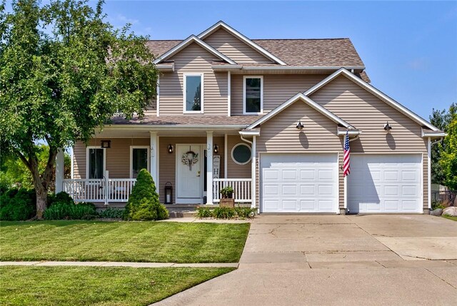 front of property featuring a porch, a garage, and a front yard