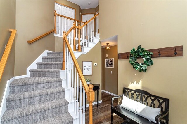 stairs featuring hardwood / wood-style floors