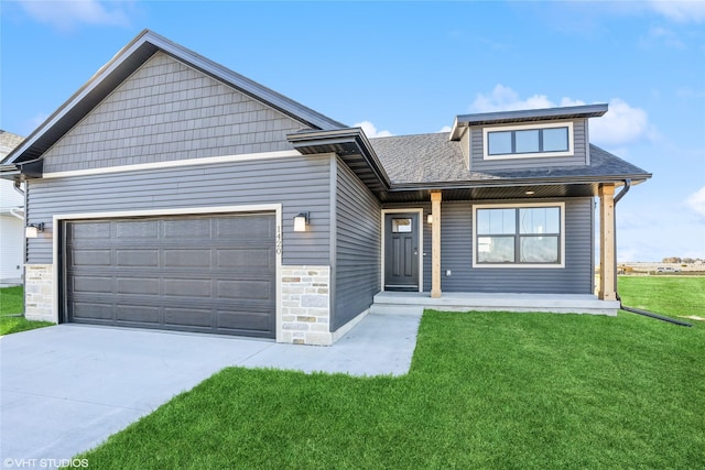 view of front of house featuring a front yard and a garage