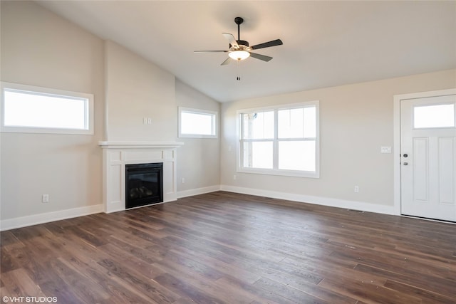 unfurnished living room featuring dark wood-type flooring, high vaulted ceiling, ceiling fan, and a healthy amount of sunlight