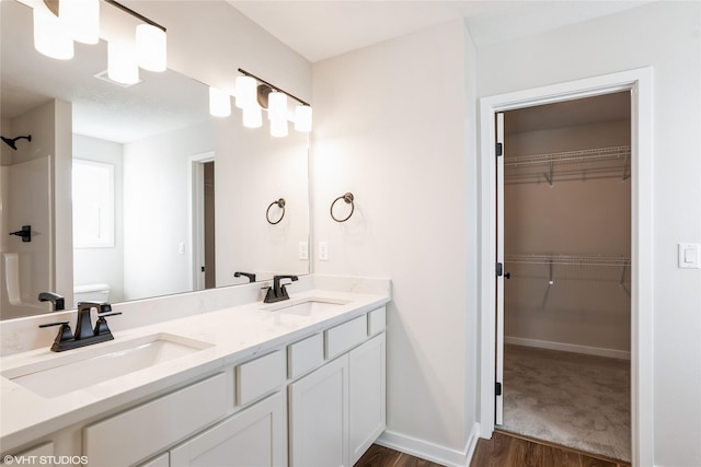 bathroom with vanity, toilet, and wood-type flooring