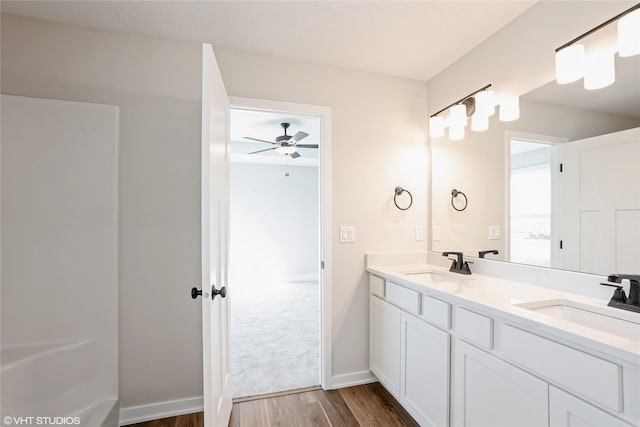 bathroom with wood-type flooring, vanity, and ceiling fan