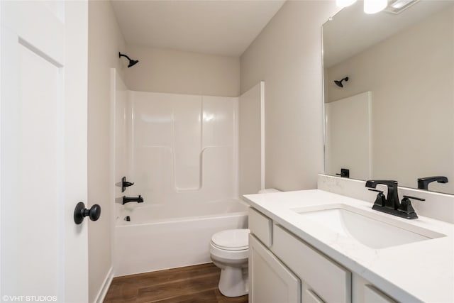 full bathroom featuring hardwood / wood-style floors, vanity, toilet, and shower / tub combination