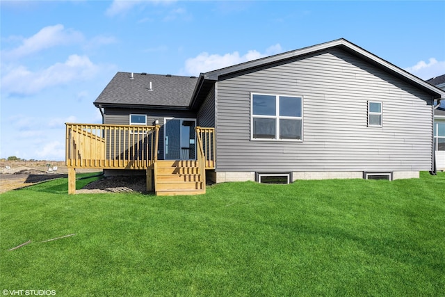 back of house featuring a lawn and a deck