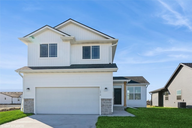 view of front of house with central AC, a front lawn, and a garage