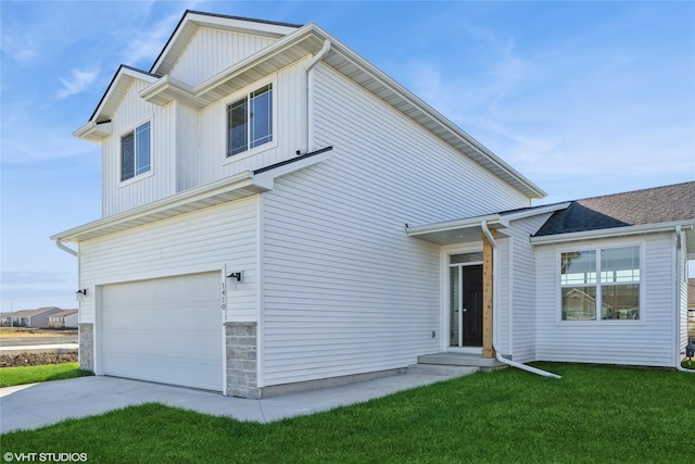 view of property featuring a front yard and a garage