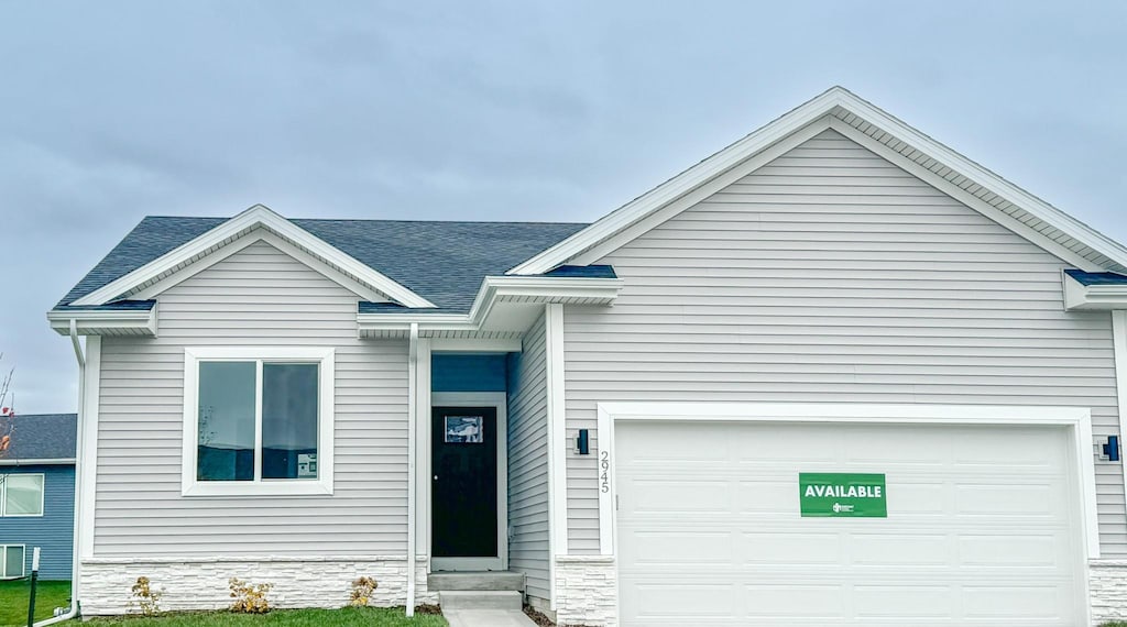 view of front of property with a front lawn and a garage