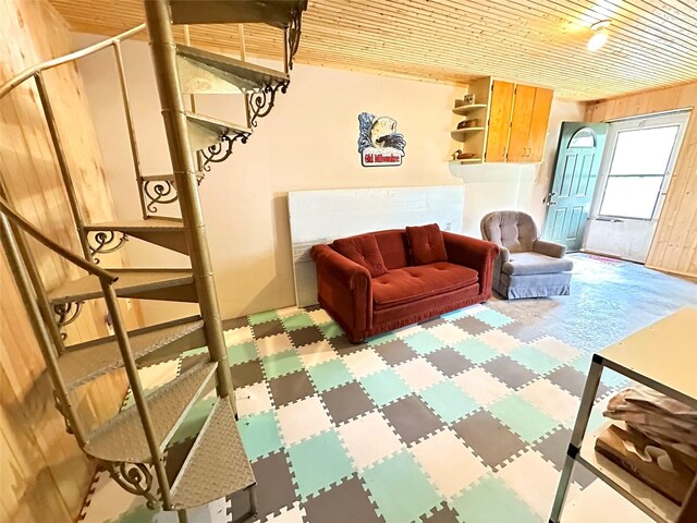 1126 Lakeshore Dr, Brooklyn, IA 52211 - living area featuring tile patterned floors, wooden ceiling, and wooden walls