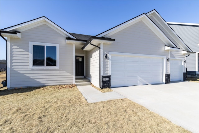 ranch-style house featuring a garage and a front yard