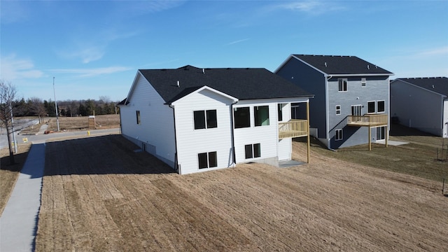 back of house featuring a deck