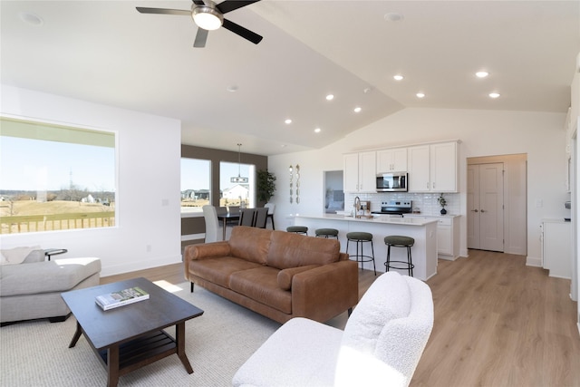 living area with recessed lighting, light wood-type flooring, and baseboards