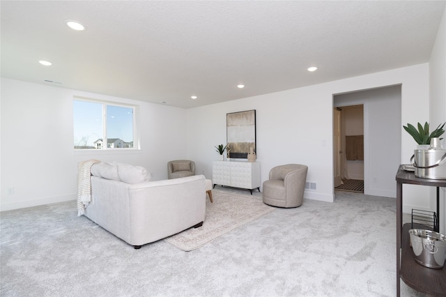 carpeted living room with baseboards, visible vents, and recessed lighting