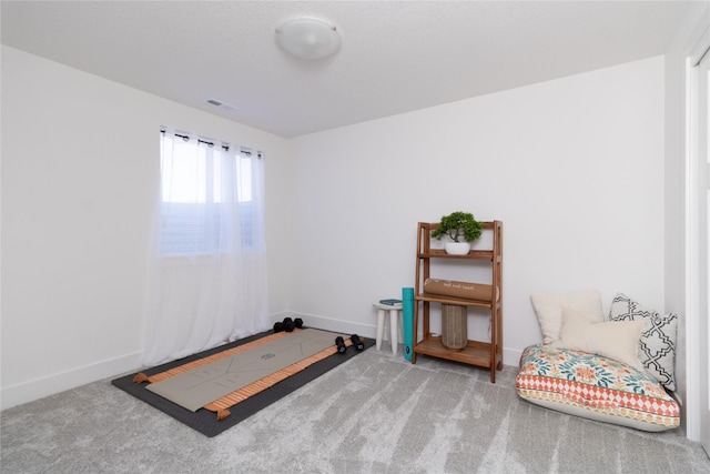 misc room featuring baseboards, visible vents, and carpet flooring