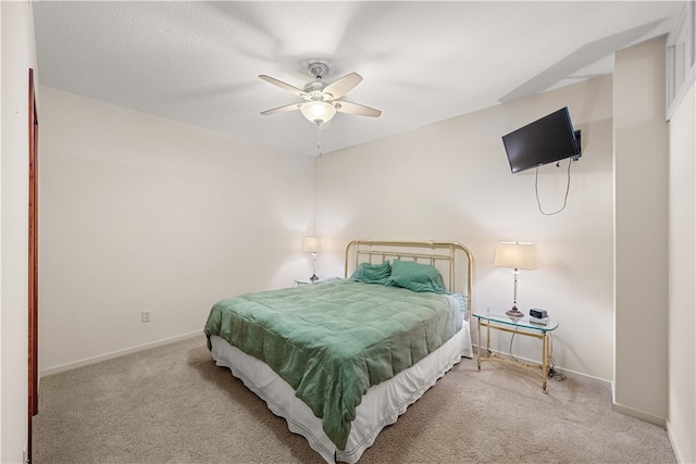 bedroom with ceiling fan and light carpet