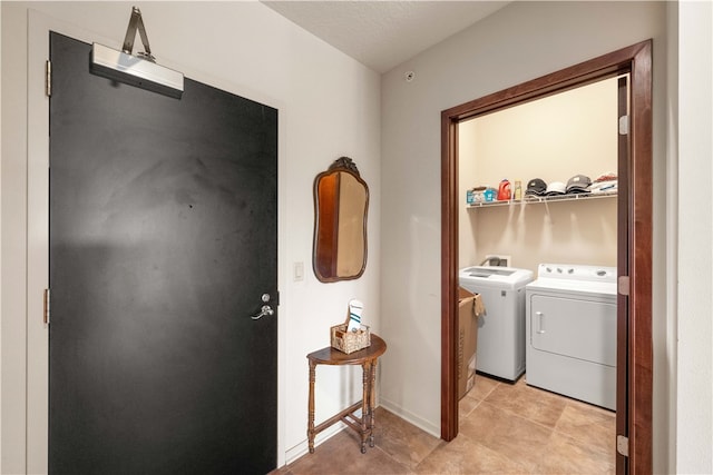 laundry room with washer and clothes dryer and a textured ceiling