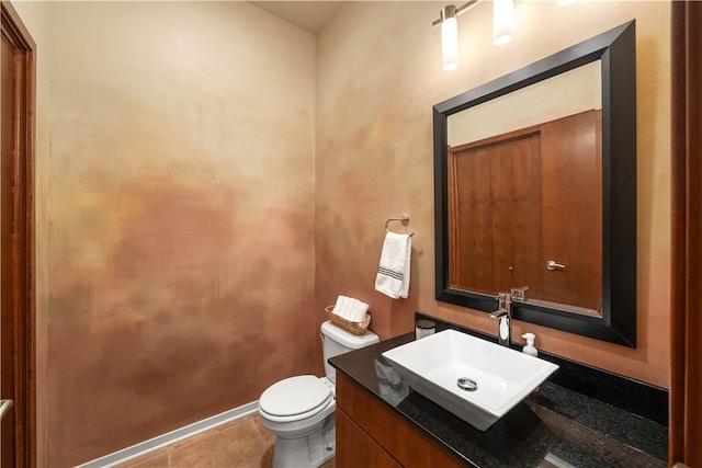 bathroom with tile patterned flooring, vanity, and toilet