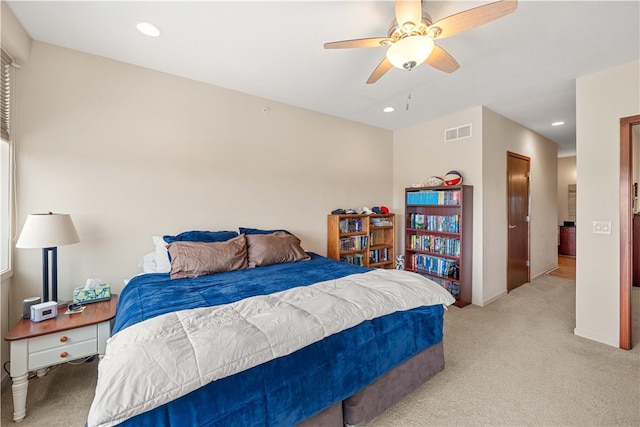 bedroom with ceiling fan and light colored carpet