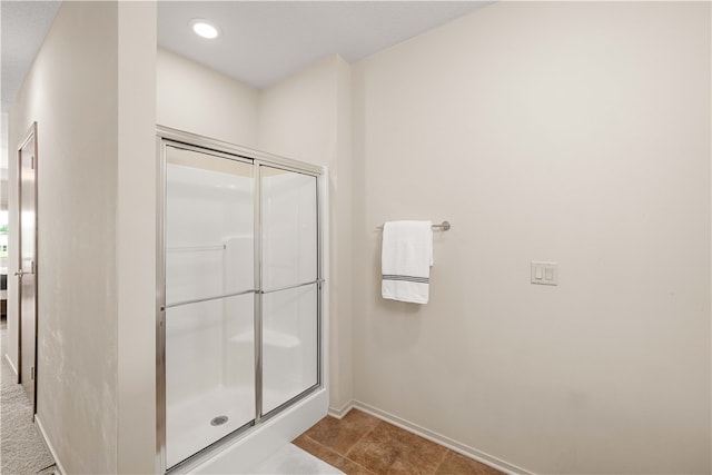 bathroom featuring tile patterned flooring and an enclosed shower