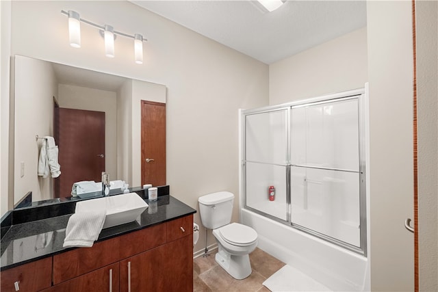 full bathroom featuring tile patterned flooring, vanity, toilet, and enclosed tub / shower combo